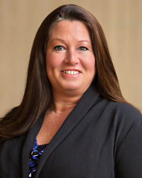 Portrait of Angela Immonen, Accounts Payable Specialist at NAI FMA Realty, standing in an office setting.