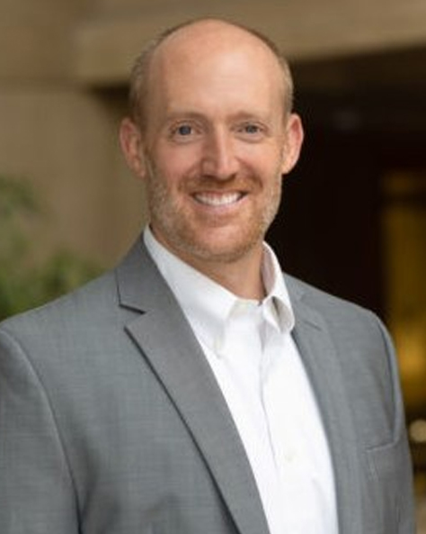 Portrait of Andy Widman, Commercial Advisor at NAI FMA Realty, in a professional indoor setting.