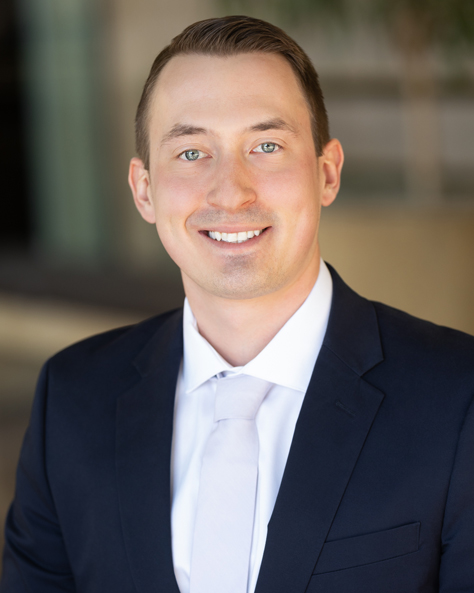 Portrait of Dan Carmichael, Vice President of Finance at NAI FMA Realty, in an office setting.