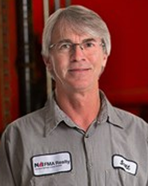 Portrait of Scott Mickle, Engineer at NAI FMA Realty, in an industrial facility setting.