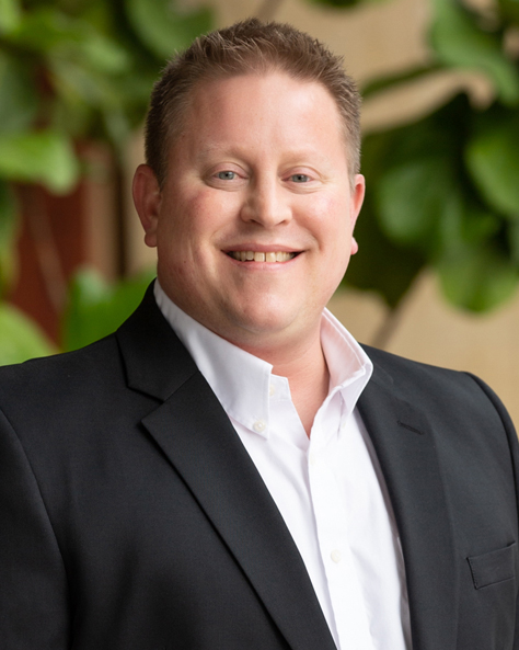 Portrait of Jamie Meyer, Property Manager at NAI FMA Realty, standing in an office setting.
