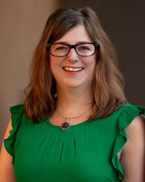 Portrait of Kari Knoedler, Transaction Manager at NAI FMA Realty, smiling in a professional office setting.