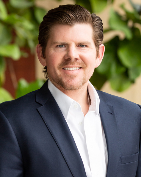 Portrait of Mike Ball, Executive Vice President of Sales and Leasing at NAI FMA Realty, standing in an office setting.