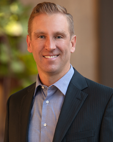 Portrait of Marc Hausmann, SIOR, CCIM, Associate Broker at NAI FMA Realty, in a professional office setting.